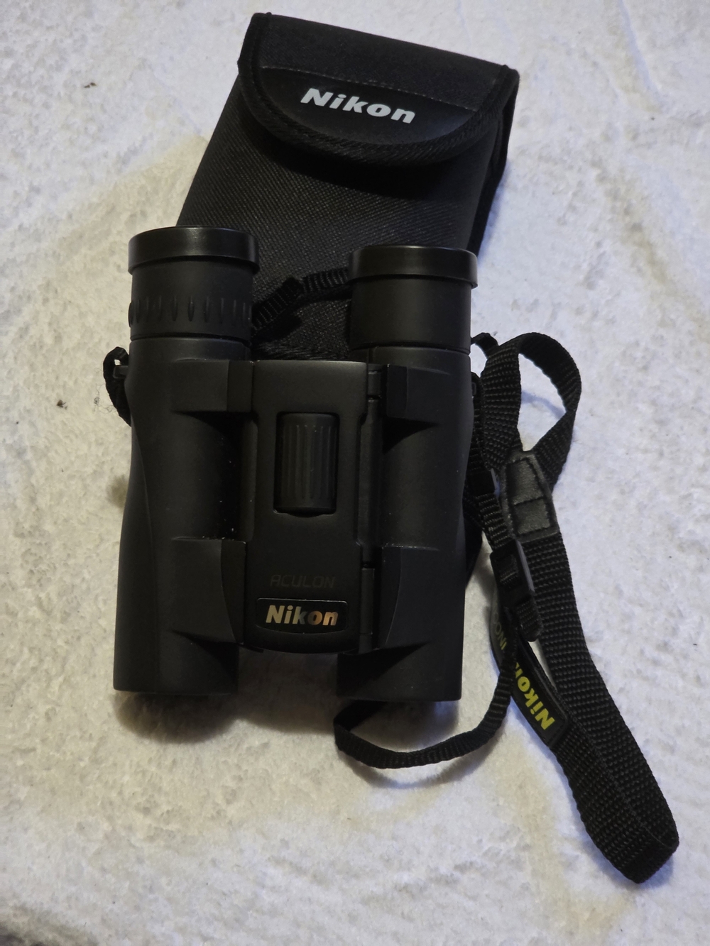 Nikon Black Compact Roof Prism Binoculars with Carry Pouch and Neck Strap 10x25